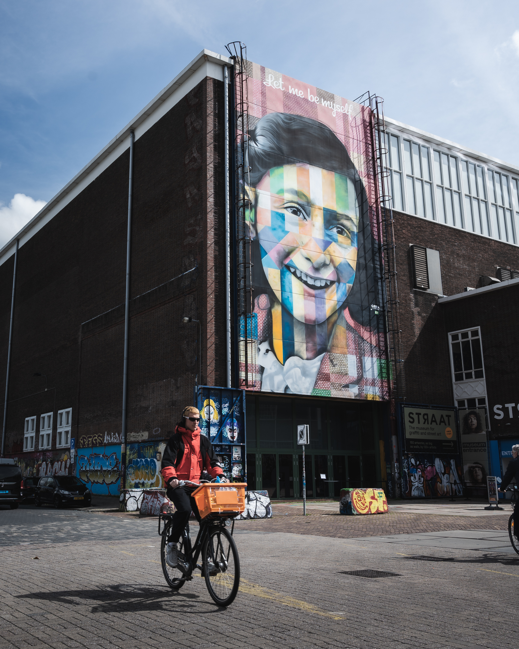 A man rides a bike past the entrance of the STRAAT Museum in the NDSM district of Amsterdam.