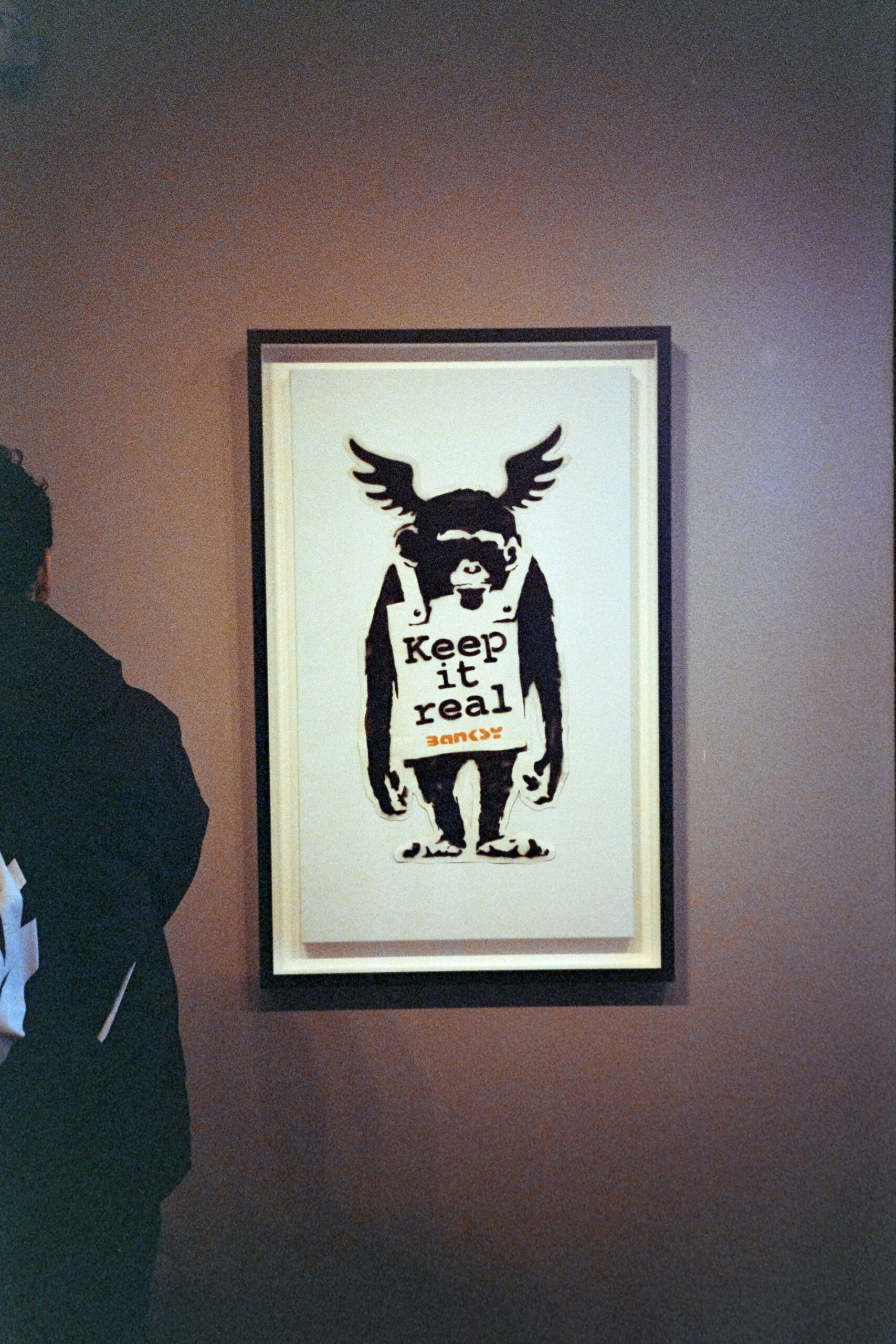 A film photo of Banksy's "Keep It Real" seen at the MOCO Museum in Amsterdam.