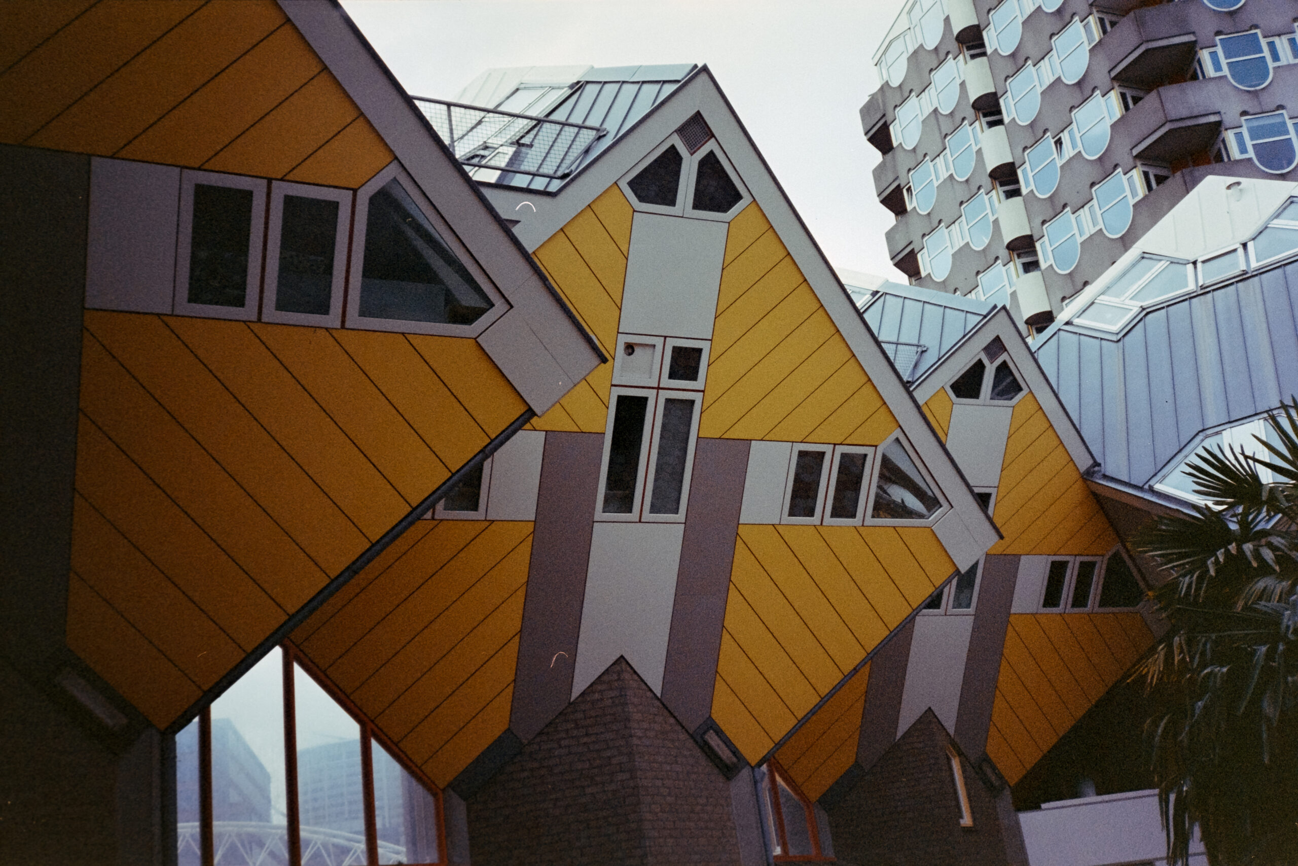 A photo of one of the iconic yellow Cube Houses in Rotterdam.
