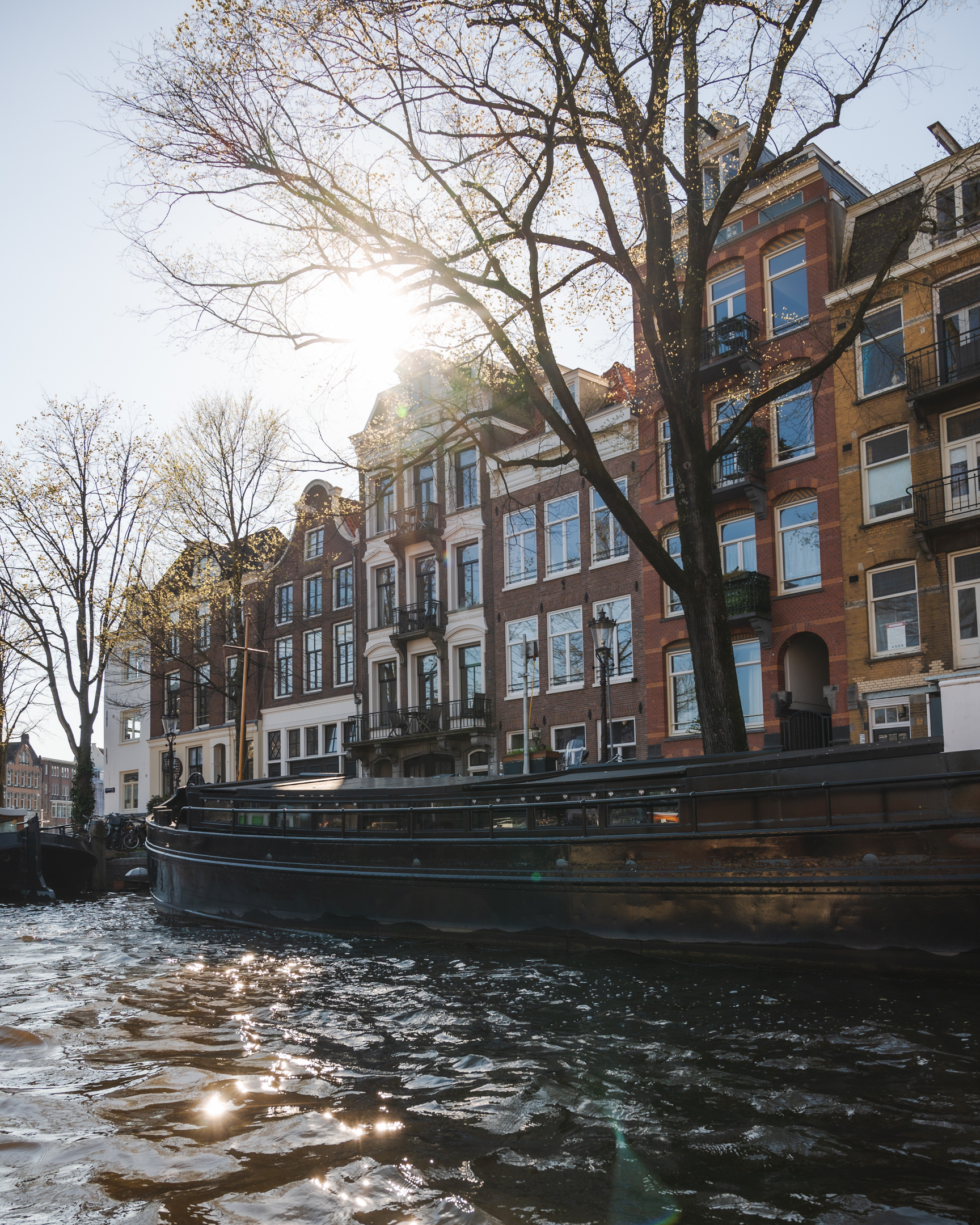 View of buildings along a canal taken during a canal cruise in Amsterdam.
