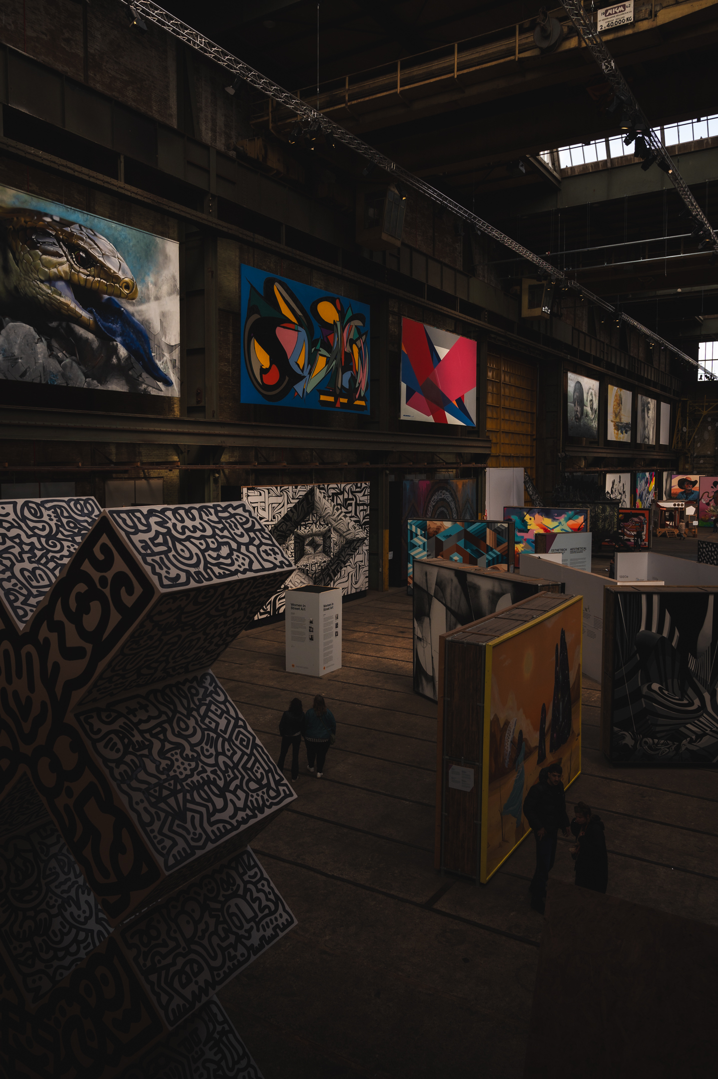 A photo of the warehouse-like interior and works of art at the STRAAT Museum in Amsterdam.